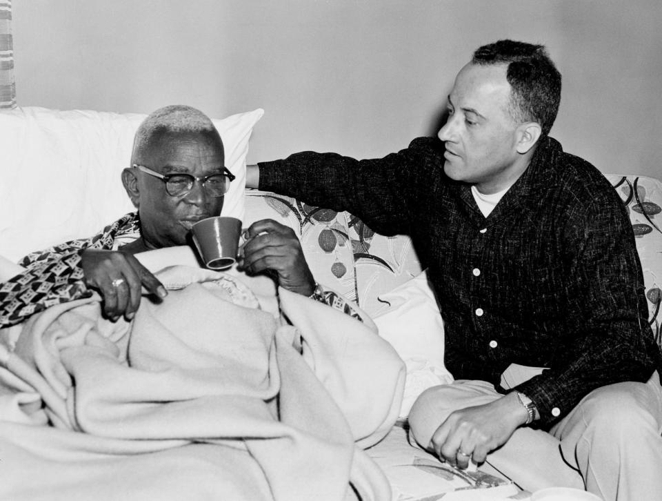 Nashville city councilman Z. Alexander Looby, left, sips coffee as his law partner, Avon Williams, comforts him after a bomb wrecked Looby's home April 19, 1960. Both are attorneys for the sit-in demonstrators.