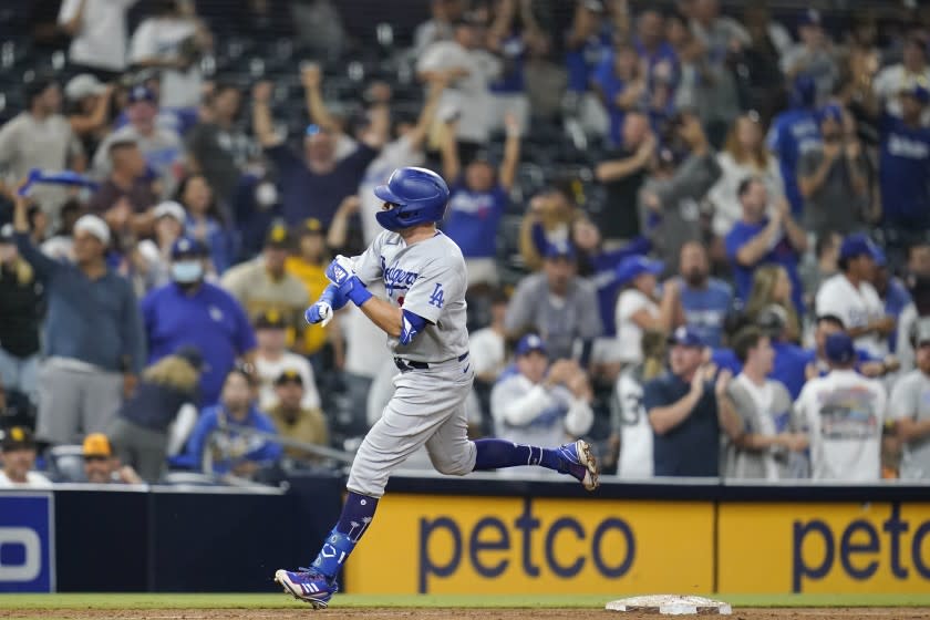 The Dodgers' AJ Pollock trots around the bases after hitting a two-run homer in the 16th inning against the San Diego Padres.