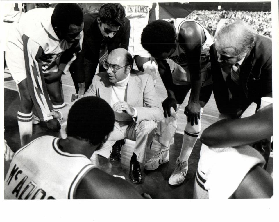 Detroit Pistons coach Dick Vitale during a huddle.