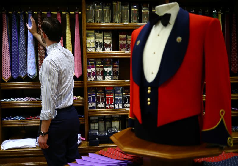 Head Shirt Cutter Tom Bradbury looks at silk ties displayed for sale in the Dege & Skinner tailors on Savile Row, amid the coronavirus disease (COVID-19) outbreak, in London