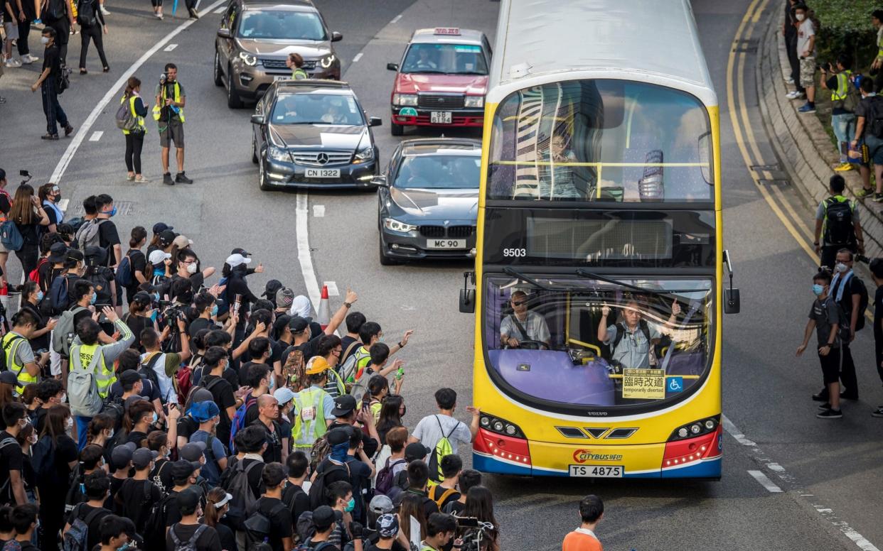 Demonstrators walk out onto Harcourt Road during a protest in the Admiralty district of Hong Kong, China, on Sunday, July 21, 2019. - Bloomberg