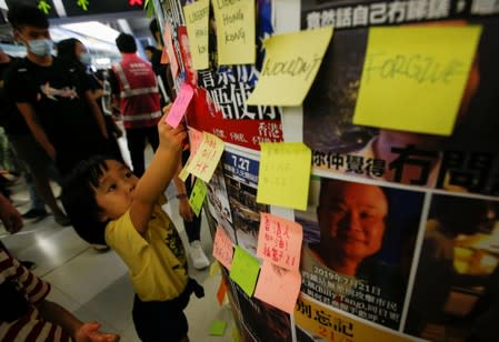 Protest at Yuen Long MTR station, the scene of an attack by suspected triad gang members a month ago, in Hong Kong