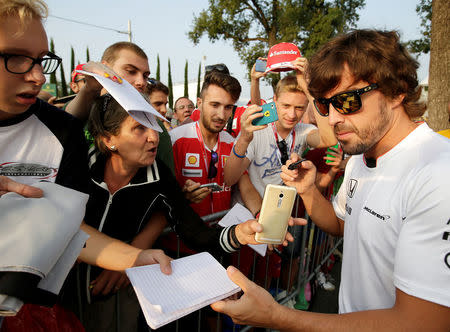 Formula One - F1 - Italian Grand Prix 2016 - Monza, Italy - 02/9/16 - McLaren's Fernando Alonso of Spain signs autographs before the first free practice. REUTERS/Max Rossi