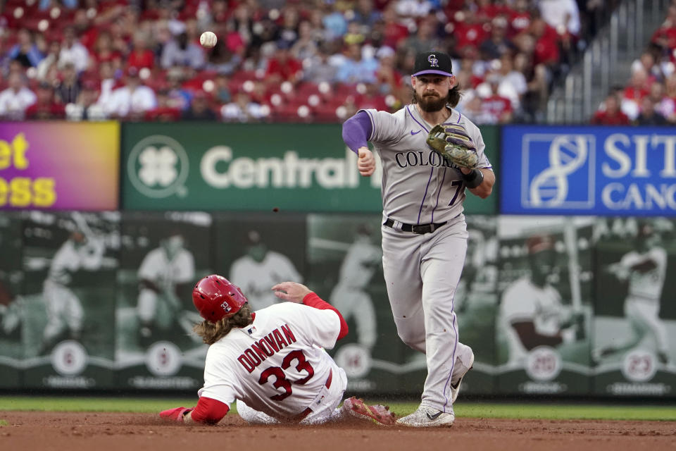 St. Louis Cardinals' Brendan Donovan (33) is out at second as Colorado Rockies second baseman Brendan Rodgers (7) turns the double play during the first inning of a baseball game Wednesday, Aug. 17, 2022, in St. Louis. The Cardinals Paul Goldschmidt was out at first. (AP Photo/Jeff Roberson)