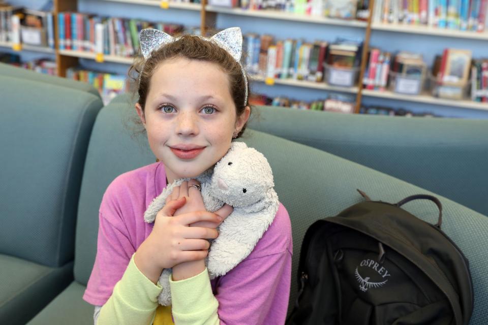 Lillie Galvin, 10, holds her stuffed animal, Bunnyella, at Mamaroneck Avenue School in Mamaroneck Dec. 15, 2023. Lillie and Bunnyella were reunited after the backpack Bunnyella was inside was lost during a summer vacation in Michigan. A couple found the backpack and mailed it to the school based on a receipt found in a book.