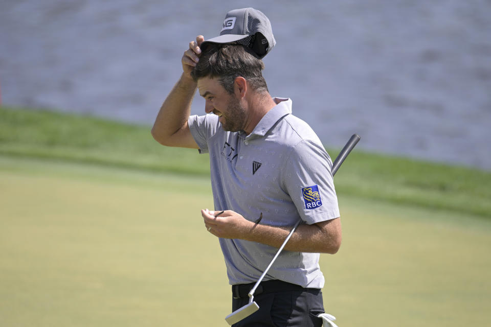 Corey Conners, of Canada, walks off the 18th green ater putting during the second round of the Arnold Palmer Invitational golf tournament, Friday, March 3, 2023, in Orlando, Fla. (AP Photo/Phelan M. Ebenhack)