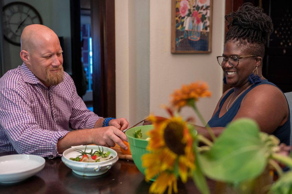 Matthew and LaKiesha Moore prepare a salad together at their Kansas City home. They moved to town during the pandemic in late 2020 and will celebrate their third wedding anniversary in a few days.