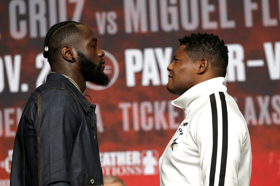 WBC heavyweight champion Deontay Wilder, left, faces off with Luis Ortiz during a final news conference at MGM Grand Garden Arena in Las Vegas Wednesday, Nov. 20, 2019. The boxers will have a rematch at the arena on Saturday, Nov. 23, 2019. (Steve Marcus/Las Vegas Sun via AP)
