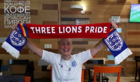 England's fan and LGBT rights campaigner Di Cunningham displays a scarf during an interview with Reuters in Volgograd, Russia, June 18 2018. REUTERS/Sergio Perez