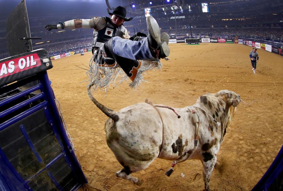 Marco Antonio Eguchi of Brazil gets bucked off of Bottoms Up in the first round of the PBR Frontier Communications Iron Cowboy at AT&T Stadium on February 18, 2017 in Arlington, Texas.