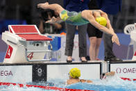 Emma McKeon of Australia, dives in for her leg of the women's 4x100m freestyle relay at the 2020 Summer Olympics, Sunday, July 25, 2021, in Tokyo, Japan. (AP Photo/Martin Meissner)