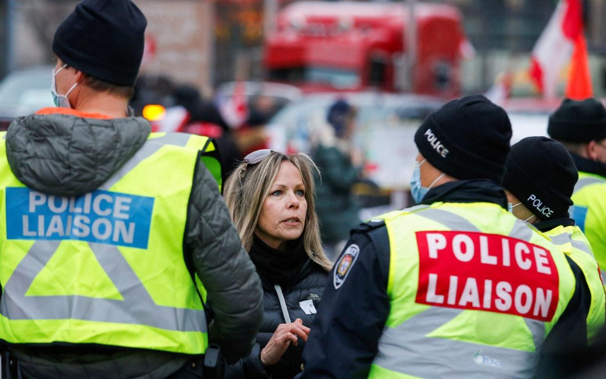 Tamara Lich, an organiser of the protest, speaks with police liaison officers as truckers and their supporters continue to protest against the coronavirus disease (COVID-19) vaccine mandates, in Ottawa, Ontario, Canada, February 10, 2022. - Patrick Doyle/Reuters