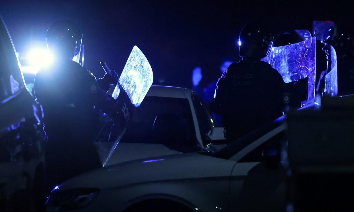 <span>Police at the Christ the Good Shepherd church in Wakeley, where a riot that broke out after an alleged stabbing attack. </span><span>Photograph: Paul Braven/EPA</span>