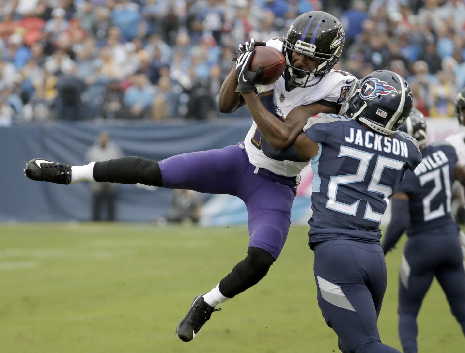 Baltimore Ravens wide receiver John Brown catches a pass as he is defended by Tennessee Titans' Adoree' Jackson (25) in the first half of an NFL football game Sunday, Oct. 14, 2018, in Nashville, Tenn. (AP Photo/James Kenney)