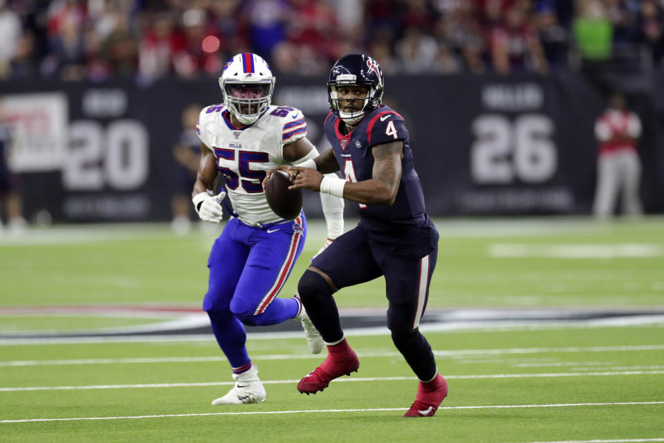 Houston Texans quarterback Deshaun Watson (4) scrambles away from Buffalo Bills defensive end Jerry Hughes (55) during the second half of an NFL wild-card playoff football game Saturday, Jan. 4, 2020, in Houston. (AP Photo/Michael Wyke)