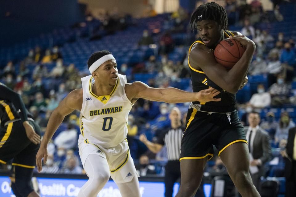 University of Delaware's Jameer Nelson Jr. (0) struggles to get the ball away from Towson's Charles Thompson Monday, Jan. 24, 2022, at The Bob Carpenter Center. Towson defeated Delaware 69-62.