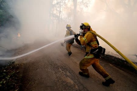 A firefighter knocks down hotspots to slow the spread of the River Fire (Mendocino Complex) in Lakeport, California, U.S. July 31, 2018. REUTERS/Fred Greaves/Files