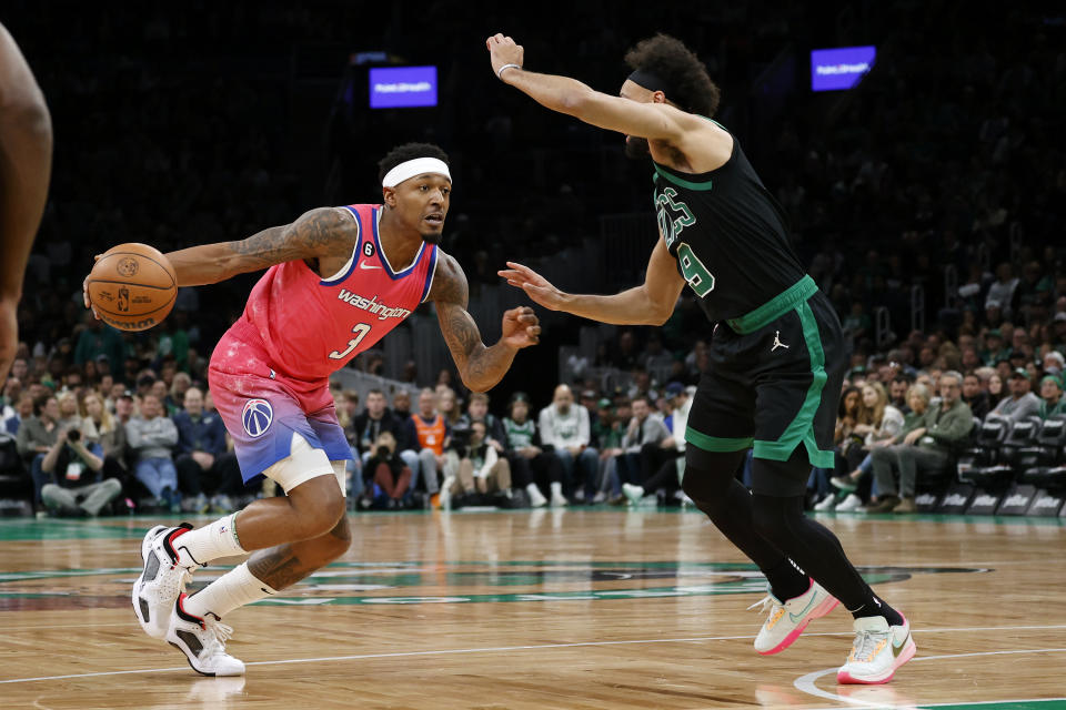 Washington Wizards guard Bradley Beal (3) drives against Boston Celtics guard Derrick White (9) during the first half of an NBA basketball game Sunday, Nov. 27, 2022, in Boston. (AP Photo/Mary Schwalm)