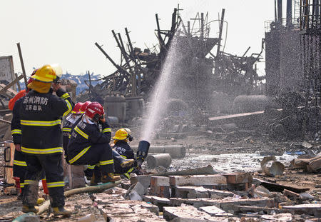 Firefighters work on the rubble of a pesticide plant owned by Tianjiayi Chemical following an explosion in Xiangshui county, Yancheng, Jiangsu province, China March 23, 2019. REUTERS/Aly Song