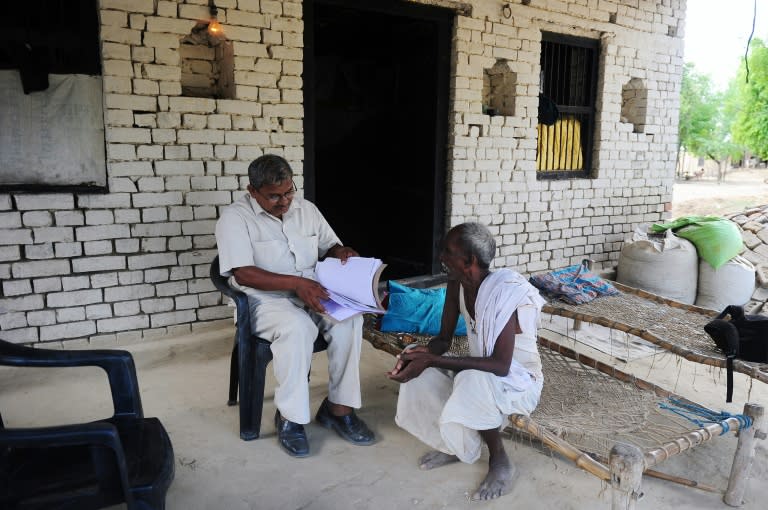 Indian farmer Ramjanam Mauriya (right), who is struggling to prove to authorities that he is still alive after being declared dead by his younger brother, speaks with activist Lal Bihari Mritak in Uttar Pradesh