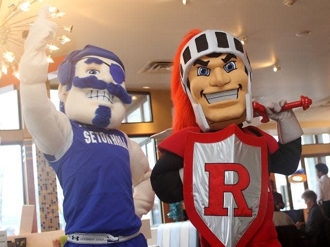 The Seton Hall Pirate and the Rutgers Scarlet Knight at a diner together.