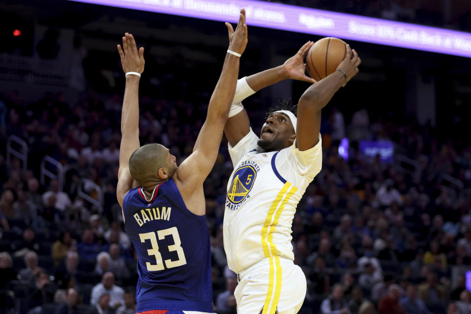 Golden State Warriors center Kevon Looney (5) shoots against Los Angeles Clippers forward Nicolas Batum (33) during the first half of an NBA basketball game in San Francisco, Tuesday, March 8, 2022. (AP Photo/Jed Jacobsohn)