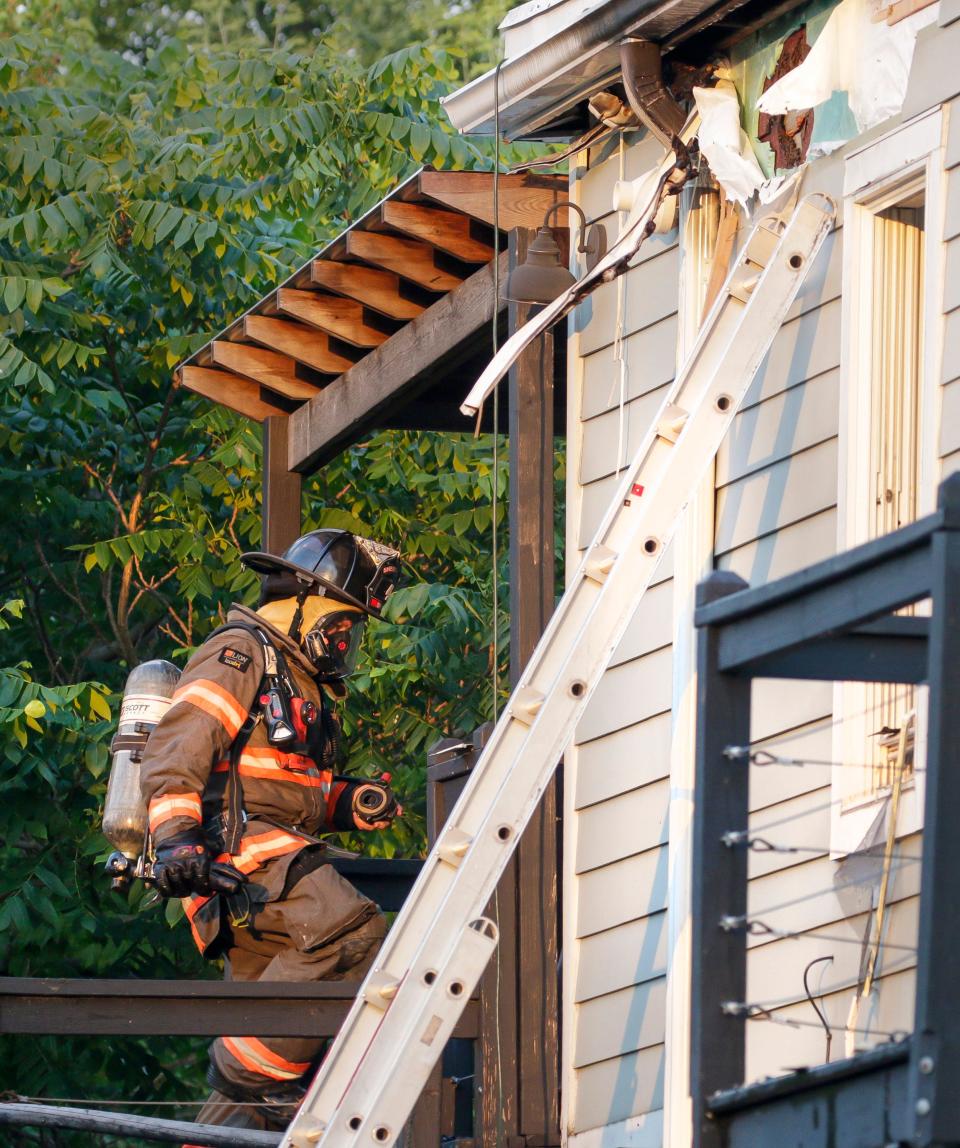 A Sheboygan firefighter enters the property at 1325-1327 North 8th Street, Friday, June 30, 2023, in Sheboygan, Wis.