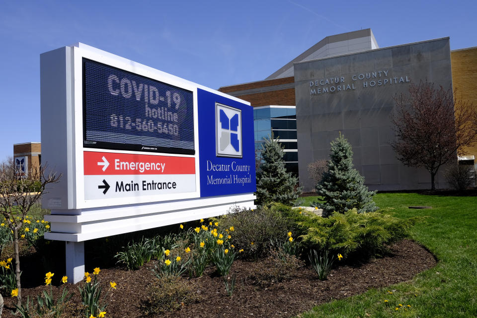 A COVID-19 hot line number is posted outside of Decatur County Memorial Hospital, Thursday, April 2, 2020, in Greensburg, Ind. Three southeast Indiana counties have among the highest per-capita coronavirus infection rates in the country. (AP Photo/Darron Cummings)