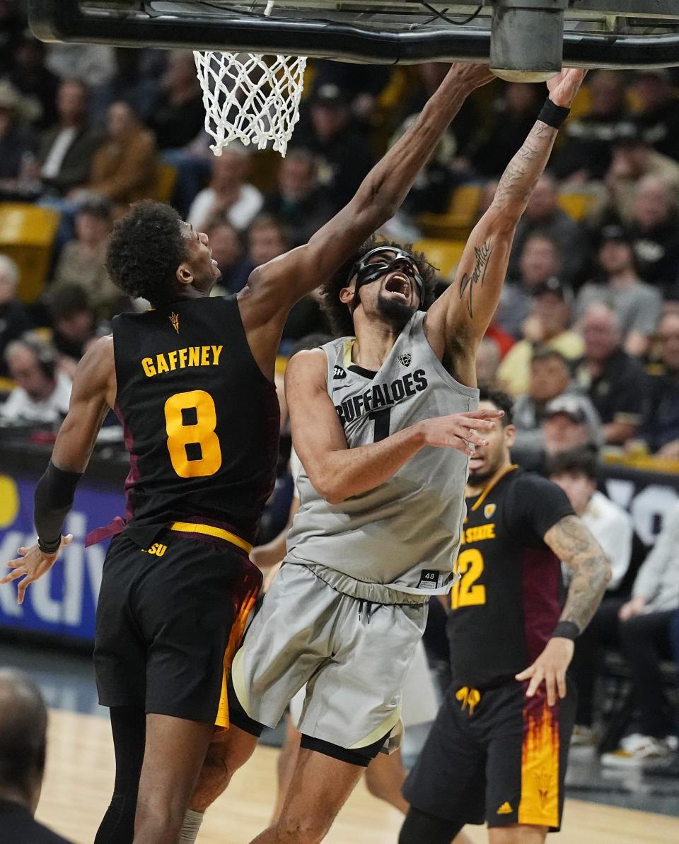 Colorado guard J'Vonne Hadley, front right, drives to the basket as Arizona State forward Alonzo Gaffney defends in the second half of an NCAA college basketball game Thursday, Feb. 8, 2024, in Boulder, Colo. (AP Photo/David Zalubowski)