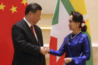 Myanmar's leader Aung San Suu Kyi, right, shakes hands with Chinese President Xi Jinping during their meeting at the Presidential Palace in Naypyitaw, Myanmar, Friday, Jan. 17, 2020. (AP Photo/Aung Shine Oo)