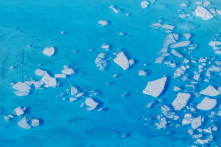 FILE PHOTO: Chunks of ice float inside of meltwater pools on top of the Helheim glacier near Tasiilaq, Greenland