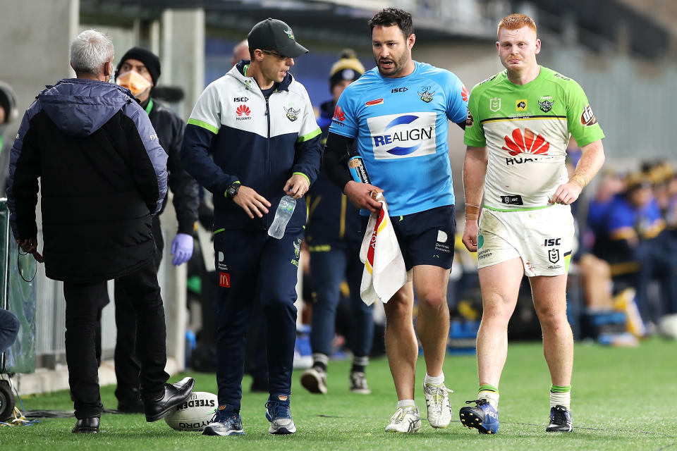 An emotional Corey Horsburgh leaves the field with the trainer.