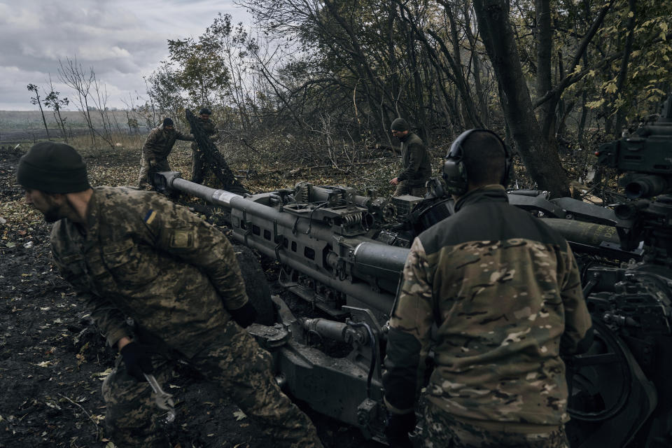 Ukrainian soldiers fire at Russian positions from a U.S.-supplied M777 howitzer in Ukraine's eastern Donetsk region Sunday, Oct. 23, 2022. (AP Photo/LIBKOS)