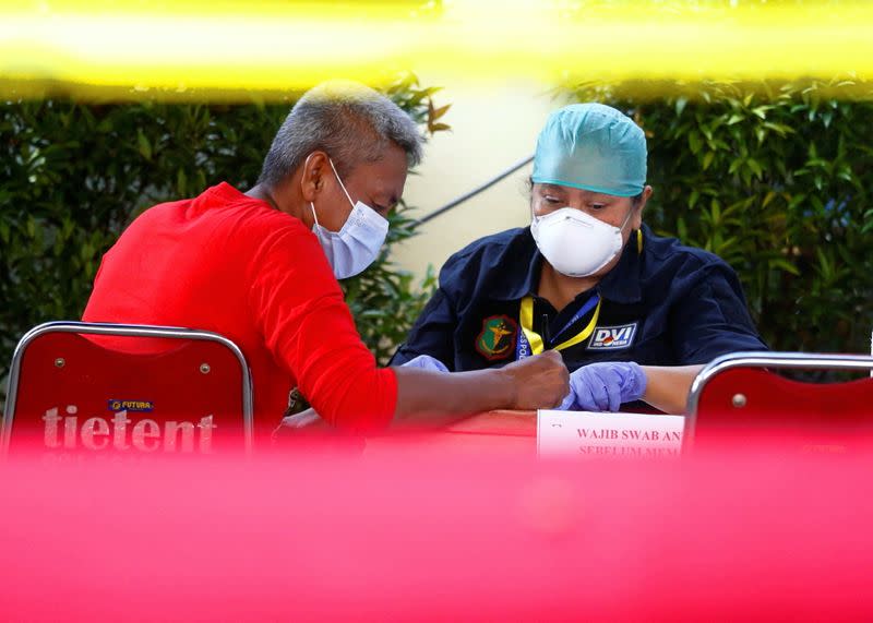 A family member of a passenger of Sriwijaya Air Flight SJ 182 is seen at a hospital after the plane crashed into the sea off the Jakarta coast, in Indonesia