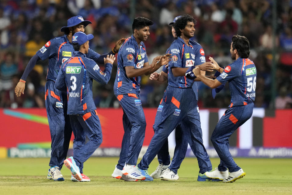 Lucknow Super Giants' Mayank Yadav, center without cap, celebrates with teammates after the dismissal of Royal Challengers Bengaluru's Glenn Maxwell during the Indian Premier League cricket match between Royal Challengers Bengaluru and Lucknow Super Giants in Bengaluru, India, Tuesday, April 2, 2024. (AP Photo/Aijaz Rahi)