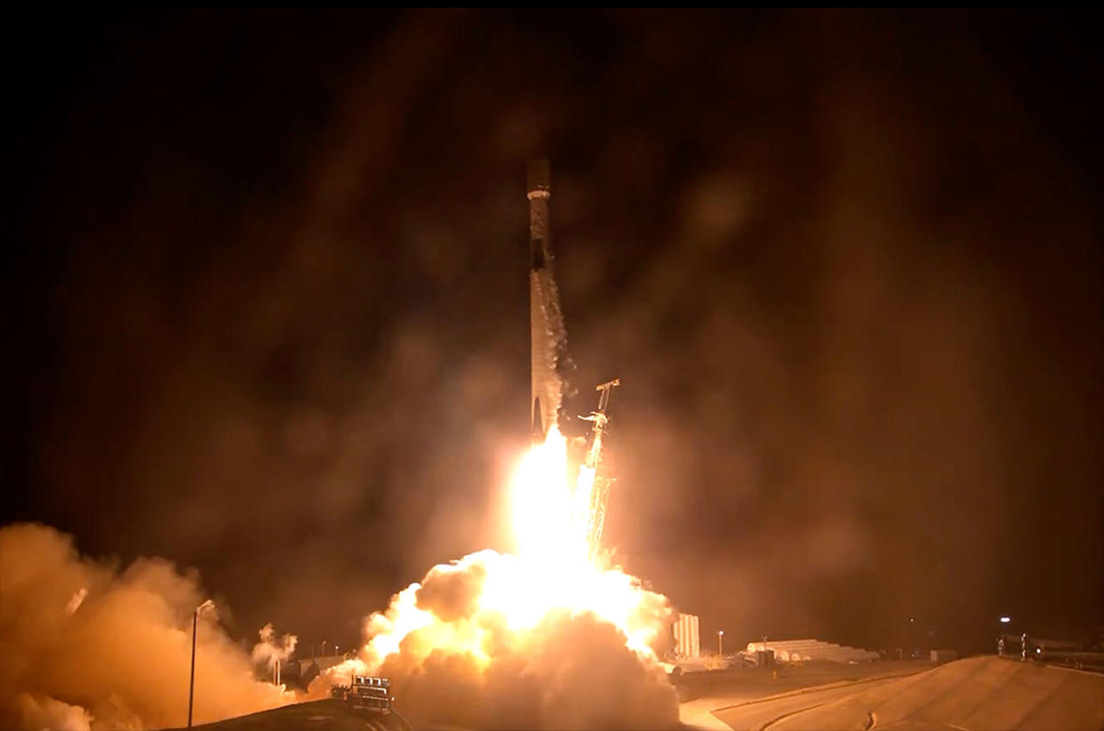  A rocket lifts off into the night sky. 