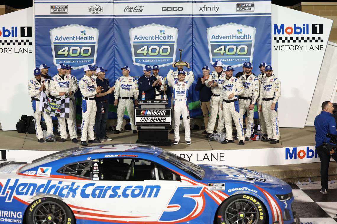 NASCAR Cup Series driver Kyle Larson celebrates with the trophy and his crew after winning Sunday’s weather-delayed AdventHealth 400 at the Kansas Speedway. Reese Strickland/USA TODAY Sports