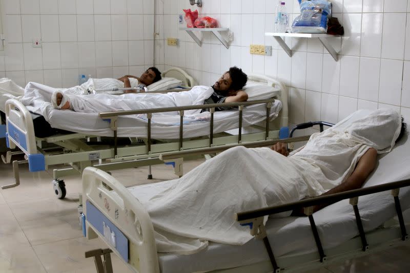 FILE PHOTO: People injured in an attack on Aden airport rest at a hospital in Aden