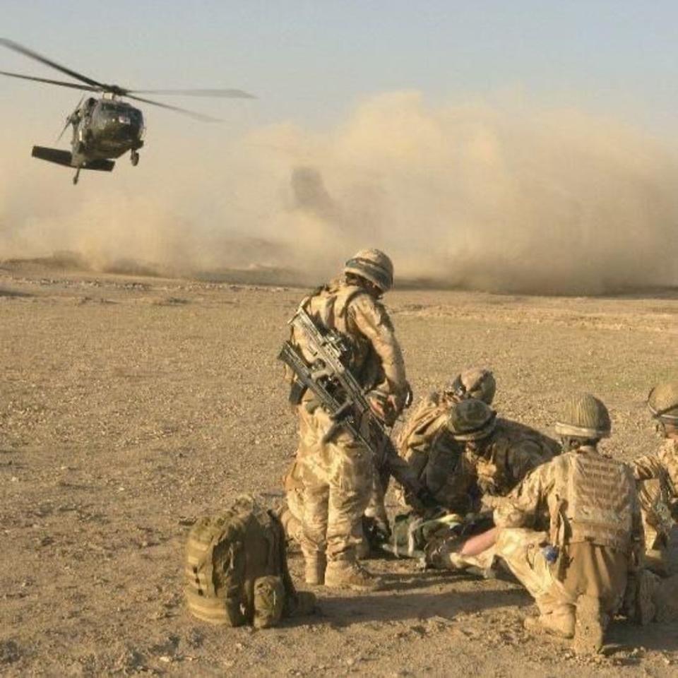 Mr Atkin being treated on the frontline after breaking his back as a machine gunner in Afghanistan in 2011 (David Atkin)