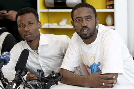 Survivors of recent shipwreck at an unknown location between Libya and Italy, Isman Mowlid of Somalia (L) and Mahmud Muaz of Ethiopia attend a news conference in Athens, Greece, April 21, 2016. REUTERS/Michalis Karagiannis