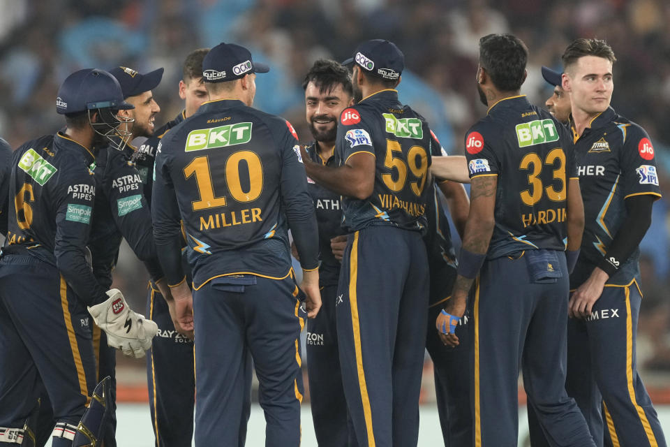 Gujarat Titan's Rashid Khan, center without cap, celebrate with teammates the dismissal of Mumbai Indian's Tilak Varma during Indian Premier League (IPL) cricket match between Mumbai Indians and Gujarat Titans, in Ahmedabad, India, Tuesday, April 25, 2023.(AP Photo/Ajit Solanki)