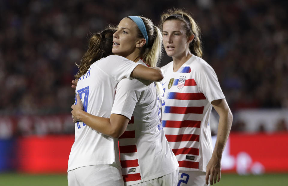 United States' Julie Ertz, center, is hugged by teammate Tobin Heath, left, after a head ball on goal from Ertz led to an own goal by Chile during the first half of an international friendly soccer match Friday, Aug. 31, 2018, in Carson, Calif. (AP Photo/Marcio Jose Sanchez)