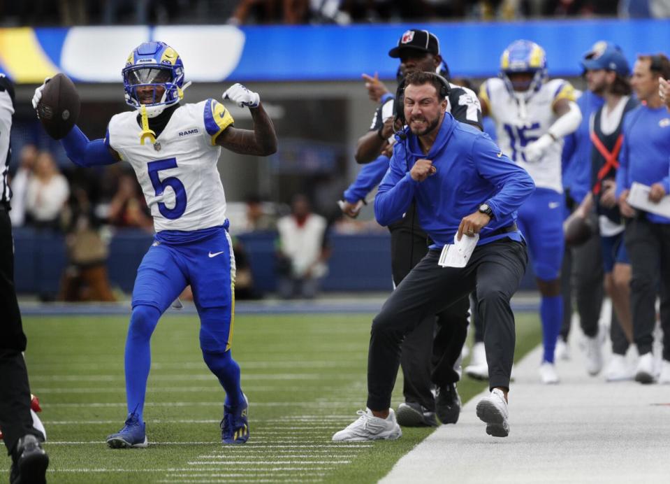 Ramsassistant coach Nick Caley reacts after Rams wide receiver Tutu Atwell (5) made a finger-tip reception.