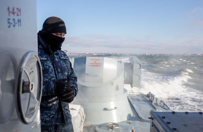 A Ukrainian navy sailor is seen on board an armoured gunboat near the Azov Sea port of Berdyansk