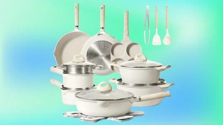 A set of kitchen pots and pans with lids and cooking utensils