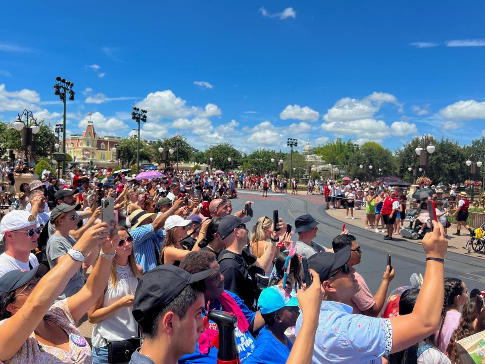 People attend the "Festival of Fantasy" parade at the Walt Disney World Magic Kingdom.