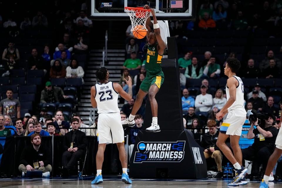 Vermont Catamounts forward Ileri Ayo-Faleye (0) dunks over Marquette Golden Eagles forward David Joplin (23) during the first round of the NCAA men's basketball tournament at Nationwide Arena. Marquette won 78-61.