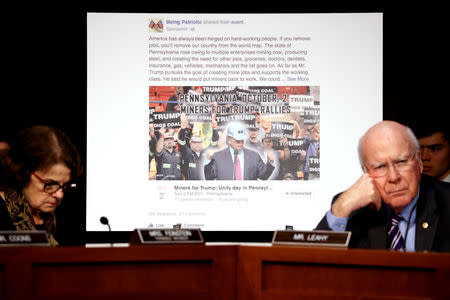 FILE PHOTO: U.S. Senator Dianne Feinstein (D-CA) (L) and Senator Pat Leahy (D-VT) show a fake social media post for a non-existent "Miners for Trump" rally as representatives of Twitter, Facebook and Google testify before a Senate Judiciary Crime and Terrorism Subcommittee hearing on how Russia allegedly used their services to try to sway the 2016 U.S. elections, on Capitol Hill in Washington, U.S. October 31, 2017. REUTERS/Jonathan Ernst/File Photo