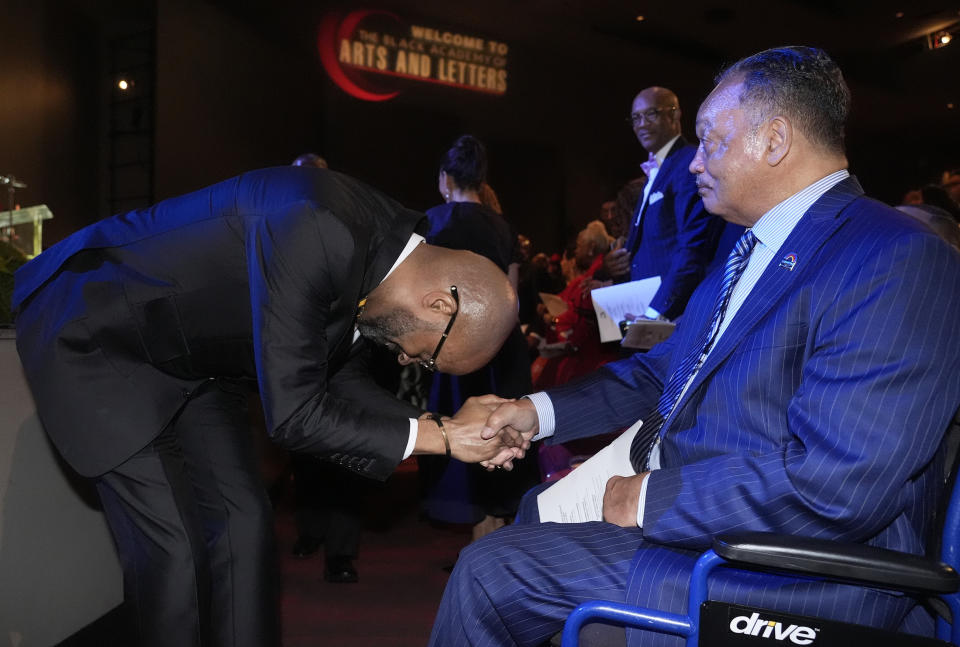 The Rev. Frederick D. Haynes III, left, bows while greeting the Rev. Jesse Jackson before speaking in Dallas, late Thursday, Feb. 1, 2024. The civil rights group founded by Jackson in the 1970s is elevating a new leader for the first time in more than 50 years, choosing Haynes as his successor to take over the Rainbow PUSH Coalition. (AP Photo/LM Otero)