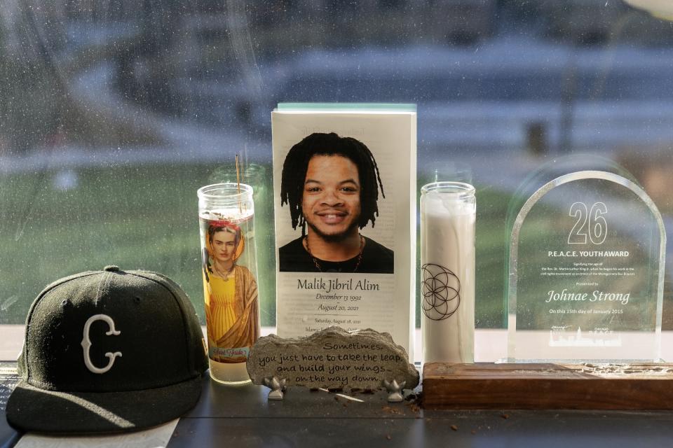 A memorial for Malik Jibril Alim is displayed in the window of Johnae Strong's home as she readies her two children for school Friday, Feb. 10, 2023, in Chicago. Strong, a single mother of two, lost her partner and father to her daughter Jari, Malik Alim, when he drowned in in a boating accident while saving Jari and his son Ori in 2021. She said she usually spends over 40 hours per week doing clerical work for a small media company and as an independent filmmaker. "Childcare is generally the biggest challenge," she said. (AP Photo/Erin Hooley)